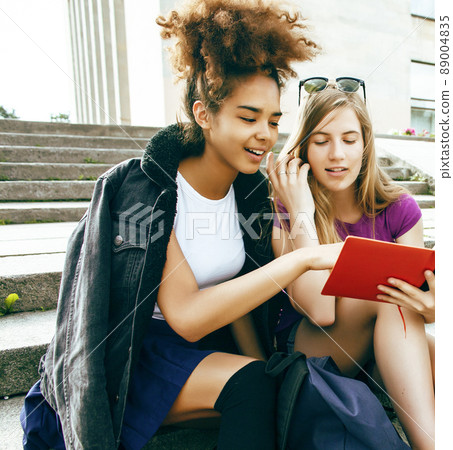 cute group of teenages at the building of university with books huggings, diversity nations, having lunch closeup cute group of teenages at the building of university with books huggings, diversity nations, having lunch closeup 89004835
