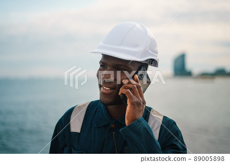 Bosun or seaman officer is speaking on the mobile cell phone 89005898