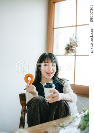 A woman eating a donut 89007362