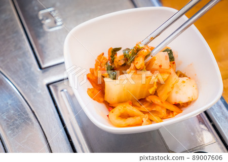 Close up of Kimchi cabbage in a bowl. It's a basic Korean side dish made of vegetables with a variety of seasonings. Close up of Kimchi cabbage in a bowl. It's a basic Korean side dish made of vegetables with a variety of seasonings. 89007606