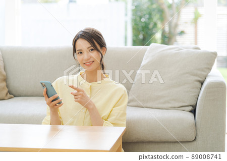 A woman relaxing at home A woman relaxing at home 89008741