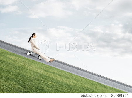 Beautiful happy woman riding downhill 89009565