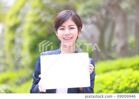Woman in navy jacket with message board 1 Woman in navy jacket with message board 1 89009946