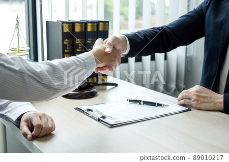 shake hand Professional man lawyers work at a law office There are scales, Scales of justice, judges gavel, and litigation documents. Concepts of law and justice shake hand Professional man lawyers work at a law office There are scales, Scales of justice, judges gavel, and litigation documents. Concepts of law and justice 89010217