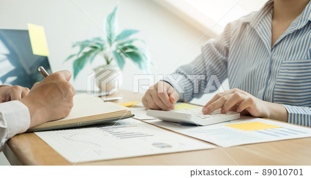 Two business leaders talk about charts, financial graphs showing results are analyzing and calculating planning strategies, business success building processes 89010701