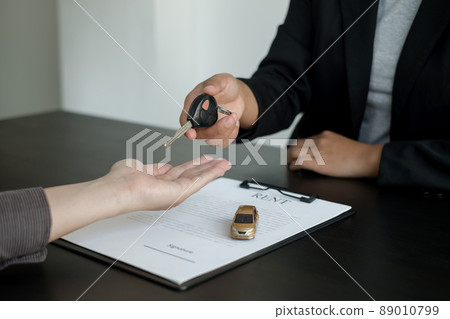 The car dealer provides advice on loans, insurance details, and car rental information, and delivers the car with the keys after the rental contract is signed 89010799