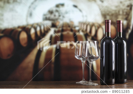 Wine cellar with wine bottle and glasses. Red wine tasting in the wine cellar. 89011285