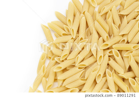 Pennette rigate. Raw pasta on white background. Space for text. 89011291