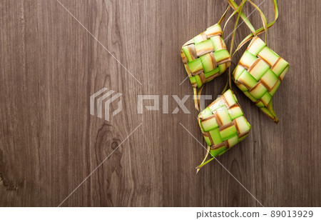 Kelongsong Ketupat decoration on wooden table. Kelongsong Ketupat decoration on wooden table. 89013929
