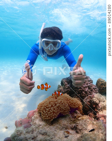 Tourist people diving with snorkel to see nemo fish , beautiful fish and coral at Samaesarn Island of Thailand 89014280