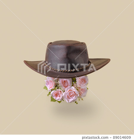 Leather retro vintage america cowboy hat and pink rose flowers. Minimal trend wild west concept. 89014609