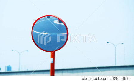 Road reflected on curve mirror 89014634