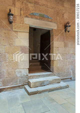Ancient decorated bricks stone wall and doorway leading to the House of Egyptian Architecture historical building, Cairo, Egypt 89017216