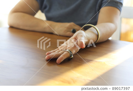 Mature woman showing her palm with life lines to chiromancer or palmist. Palmistry and chiromancy 89017397
