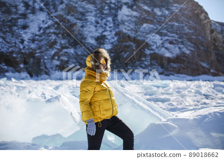 Portrait of happy real pretty woman in fur coat and yellow hat at winter background. Portrait of happy real pretty woman in fur coat and yellow hat at winter background. 89018662