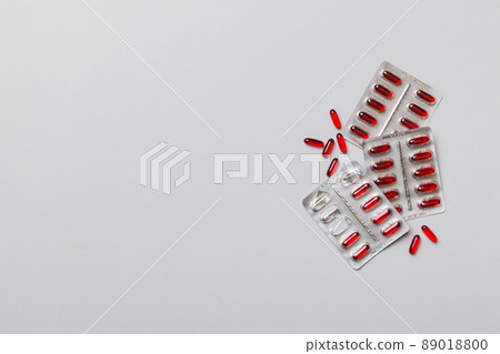 Protective face masks or surgical masks, medicine pills and thermometer on table background. Coronavirus disease. Corona virus concept. Space for text 89018800