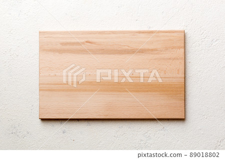 Top view of wooden cutting board on cement background. Empty space for your design 89018802