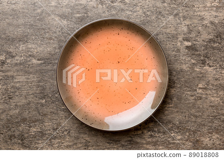 Top view of empty red plate on cement background. Empty space for your design Top view of empty red plate on cement background. Empty space for your design 89018808