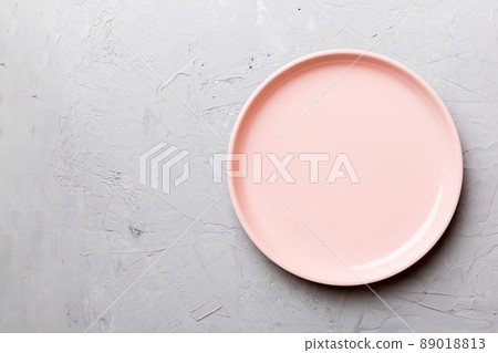 Top view of empty pink plate on cement background. Empty space for your design 89018813