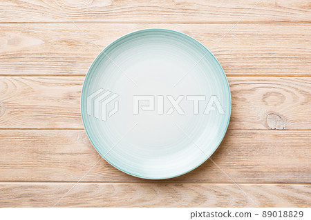 Top view of empty blue plate on wooden background. Empty space for your design Top view of empty blue plate on wooden background. Empty space for your design 89018829