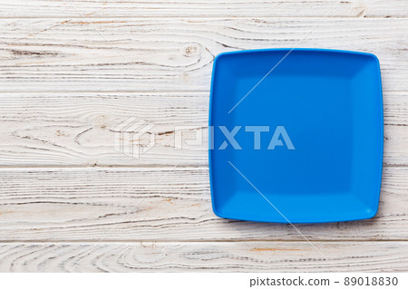 Top view of empty square plate on wooden background. Empty space for your design Top view of empty square plate on wooden background. Empty space for your design 89018830