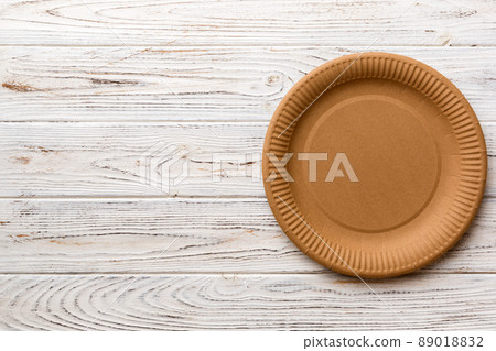 Top view of eco paper plate on wooden background. Empty space for your design Top view of eco paper plate on wooden background. Empty space for your design 89018832