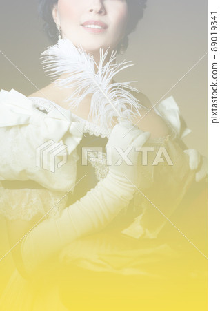 Gradient from gray to yellow. A lady with a smile in a historical costume with a feather in her hand and a letter. Design for the cover of the book. High quality photo Gradient from gray to yellow. A lady with a smile in a historical costume with a feather in her hand and a letter. Design for the cover of the book. High quality photo 89019341