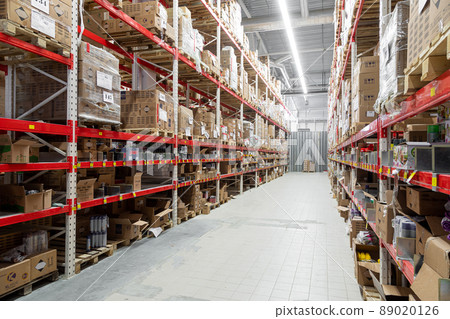 long corridor between high racks at the logistics center 89020126
