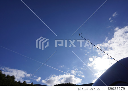 Blue sky, dragonflies and contrails Blue sky, dragonflies and contrails 89022279