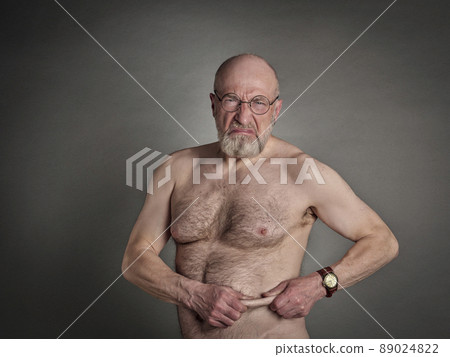 athletic senior man is not happy with his belly fat 89024822
