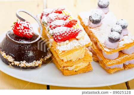 selection of fresh cream cake dessert plate 89025128