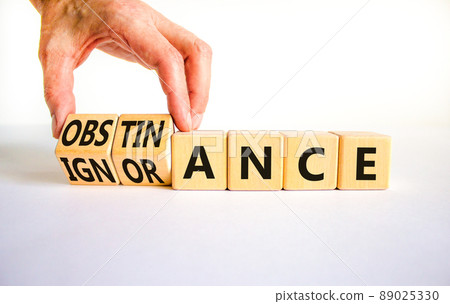 Obstinance or ignorance symbol. Businessman turns cubes, changes the word ignorance to obstinance. Beautiful white table, white background. Business, obstinance or ignorance concept. Copy space. Obstinance or ignorance symbol. Businessman turns cubes, changes the word ignorance to obstinance. Beautiful white table, white background. Business, obstinance or ignorance concept. Copy space. 89025330