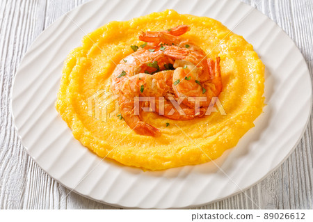 polenta with fried shrimps on plate, top view polenta with fried shrimps on plate, top view 89026612