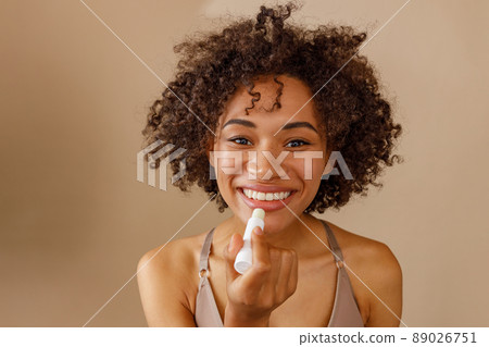 Portrait of cheerful model woman standing in studio Portrait of cheerful model woman standing in studio 89026751