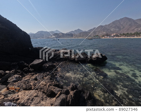 Incredible view from island to beach, small sandy beach on the island, coral reef, fujairah. High quality photo 89027346