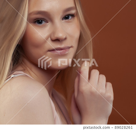 young pretty girl with blond hair posing cheerful on brown background, lifestyle people concept young pretty girl with blond hair posing cheerful on brown background, lifestyle people concept 89028261