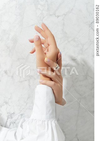 Manicured womans hands with trendy minimal jewelry. Fashion accessories 89030162