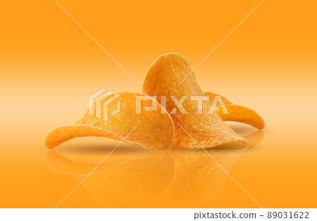Potato crisps on a yellow background with copy space for text or images, mirror surface. Advertising concept. Close-up shot. 89031622