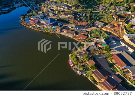 Aerial view of Sunrise with fog over Ban Rak thai, chinese village near a lake in Mae Hong Son Aerial view of Sunrise with fog over Ban Rak thai, chinese village near a lake in Mae Hong Son 89032757