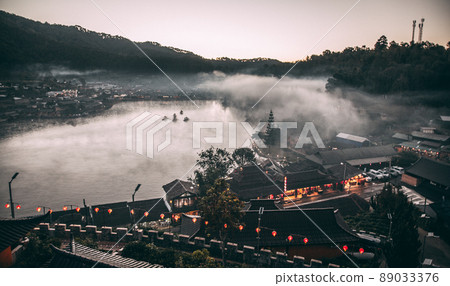 Sunrise with fog over Ban Rak thai, chinese village near a lake in Mae Hong Son, Thailand Sunrise with fog over Ban Rak thai, chinese village near a lake in Mae Hong Son, Thailand 89033376