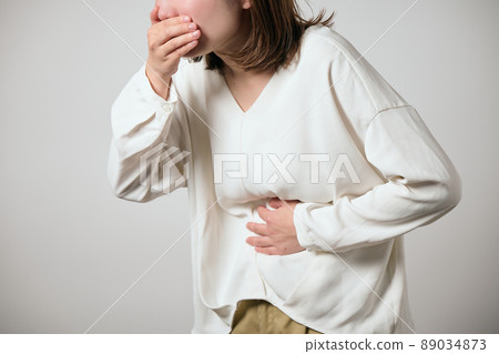 Young woman with food poisoning, nausea and abdominal pain Young woman with food poisoning, nausea and abdominal pain 89034873