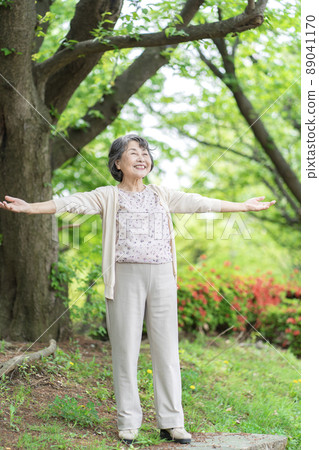 Senior woman taking a deep breath in the park 89041170