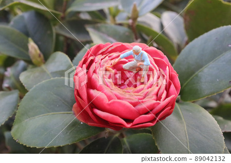 a mini Painter holding a brush, paint the flower a mini Painter holding a brush, paint the flower 89042132