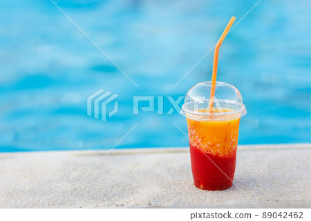 fresh mango with strawberry juice or smoothie near the pool 89042462