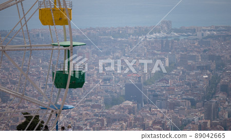 Ferris wheel on cloudy sky background. Cloudy overview on the city 89042665