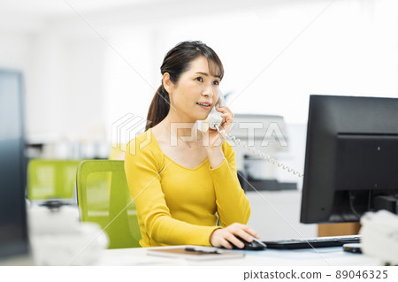 Middle career woman calling in the office 89046325