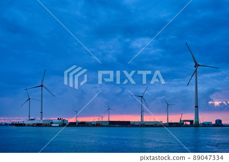 Wind turbines in Antwerp port in the evening 89047334