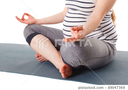 Pregnant woman doing yoga asana asana Sukhasana with chin mudra 89047369