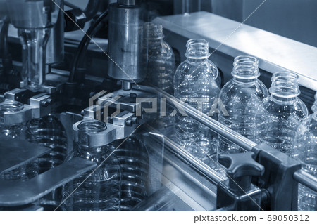 The abstract scene of plastic processing of PET bottles in the drinking water factory. 89050312