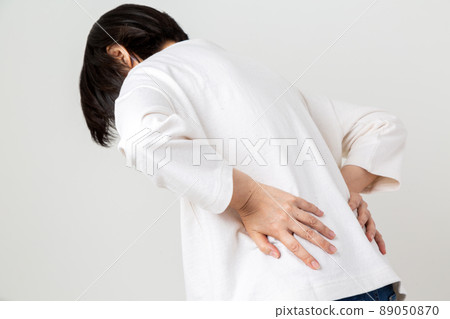 Middle women suffering from low back pain Middle women suffering from low back pain 89050870